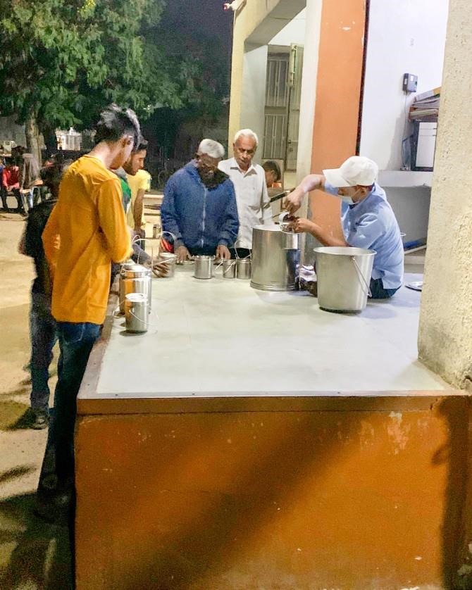 Smallholder farmers in India bring milk from their cows to a community dairy cooperative daily. They get paid for the milk on the spot.