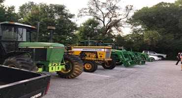 High school students drive tractors to school