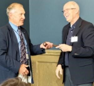 Ron Suppes, left, accepts the ceremonial gavel from outgoing Wheat Foods Council (WFC) Chairman Kent Juliot at the WFC Board Meeting in Denver on June 14.