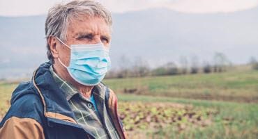 Farmer wearing a mask