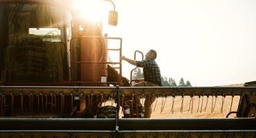 Farmer climbing in combine