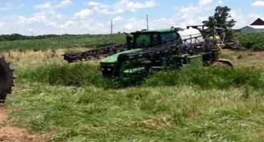 John Deere tractor helps a sprayer in need