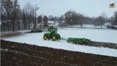 JOHN DEERE 8RX Tractors Ripping a Snow Covered Field.