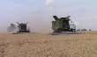 John Deere S670 Combines Harvesting Wheat