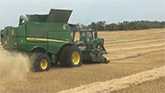 John Deere S790 combines combining wheat in Saskatchewan