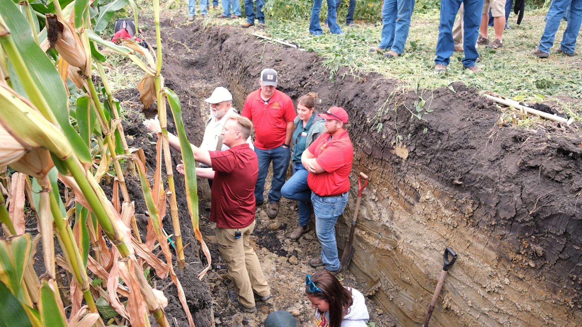 At a recent field day hosted by the Southeast Research and Demonstration Farm, Bradley Miller and other Iowa State University soil scientists discuss land resources with farmers and answer questions about soil organic matter, compaction and soil water storage. Photo by Brent Pringnitz, Iowa State University Extension. 