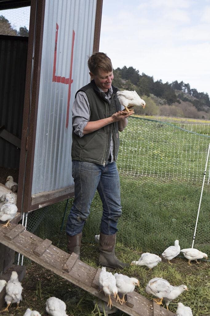 Dede Bois with chickens at Root Down Farm. Photo by Anne Hamersky.