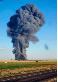 In this photo provided by Castro County Emergency Management, smoke fills the sky after an explosion and fire at the Southfork Dairy Farms near Dimmitt, Texas, on April 10, 2023. A fire and explosion at the dairy farm in the Texas Panhandle that critically injured one person and killed an estimated 18,000 head of cattle was an accident that started with an engine fire in a manure vacuum truck cleaning part of the massive barn, according to state investigators in a report on April 24.