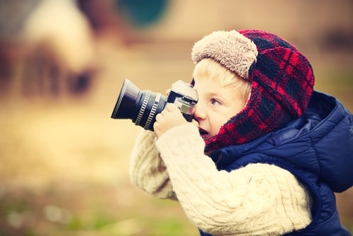 Little boy taking a picture on a farm
