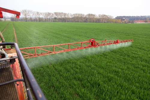 Tractor applying fungicide
