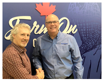 Rob Flack (right), president and CEO of Masterfeeds, congratulates Mark Bodenham (left) on assuming the position of general manager for Ontario, effective March 22, 2019. 